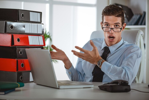 Working-at-laptop-looking-at-documents-and-accounts