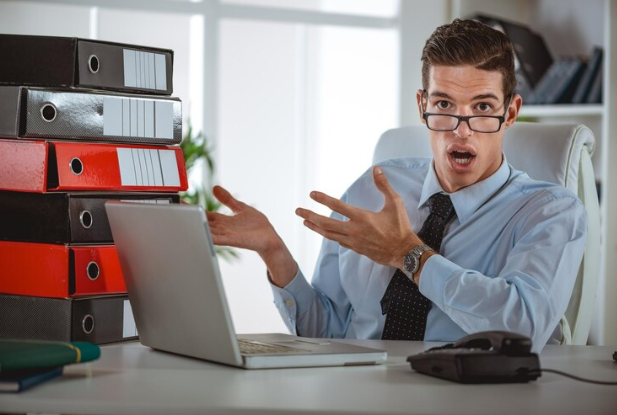 Working-at-laptop-looking-at-documents-and-accounts